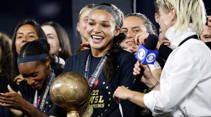 Sophia Smith holds the MVP trophy after the Portland Thorns win the 2022 NWSL championship.